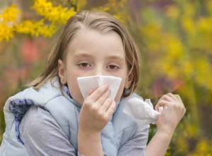 Little girl blowing her nose