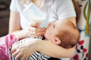 Baby drinking milk from bottle