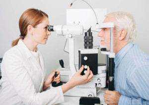 Senior patient checking vision with special eye equipment